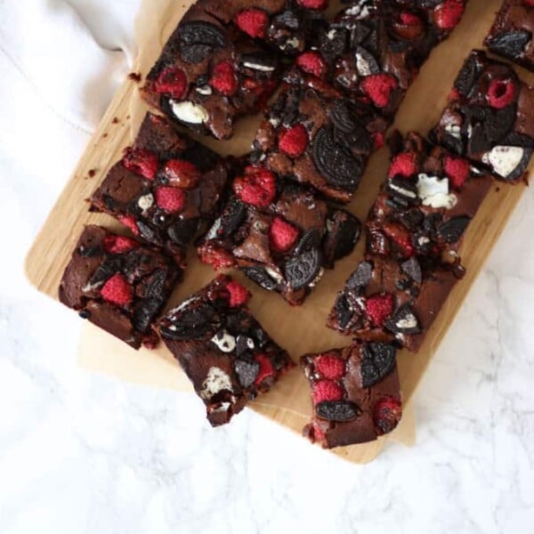 Fudgy, gooey, brownies, with a double layer of Oreos and raspberries. Because fresh fruit cancels out the chocolate, right?! A delicious birthday cake, piled high on a plate or a dessert, served with vanilla ice cream. https://pattern-ward.live