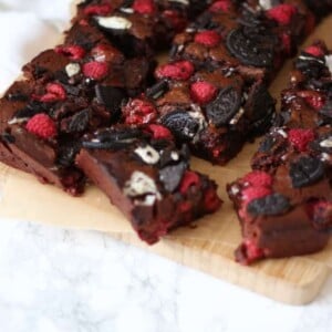 Fudgy, gooey, brownies, with a double layer of Oreos and raspberries. Because fresh fruit cancels out the chocolate, right?! A delicious birthday cake, piled high on a plate or a dessert, served with vanilla ice cream. https://pattern-ward.live