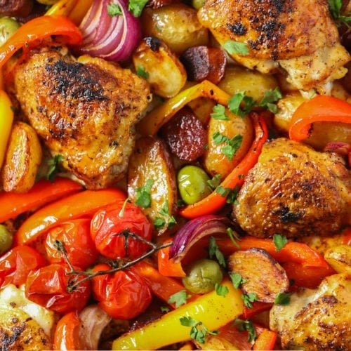 Easy spanish chicken and chorizo tray bake recipe sprinkled with parsley.