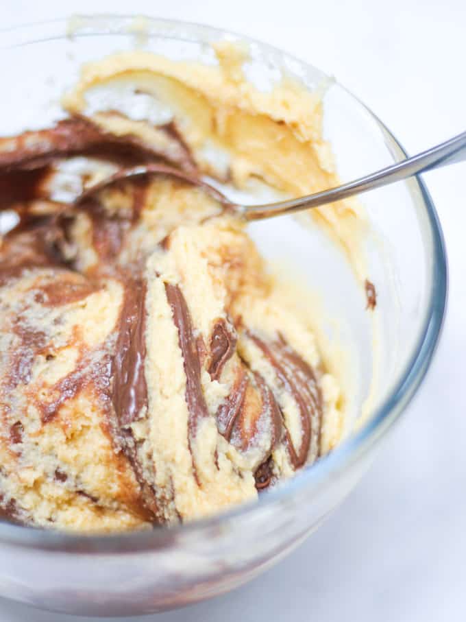 Marble cake mixture raw in glass bowl of Nutella Cake.
