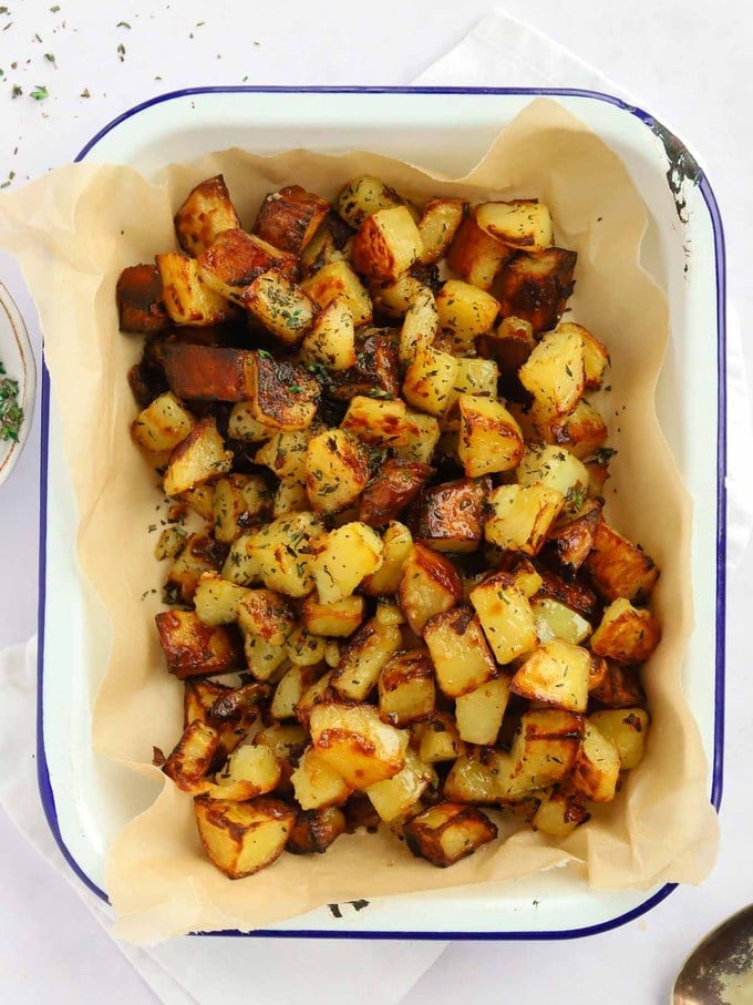 An oven dish filled with baked golden parmentier potatoes.