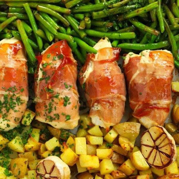 Prosciutto wrapped chicken served with cubes of potatoes and green beans.