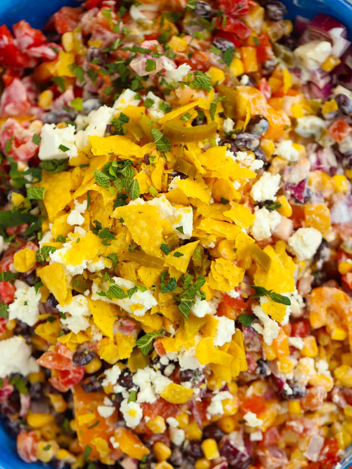 A close up of Mexican Salad ingredients in a bowl, mixed together.