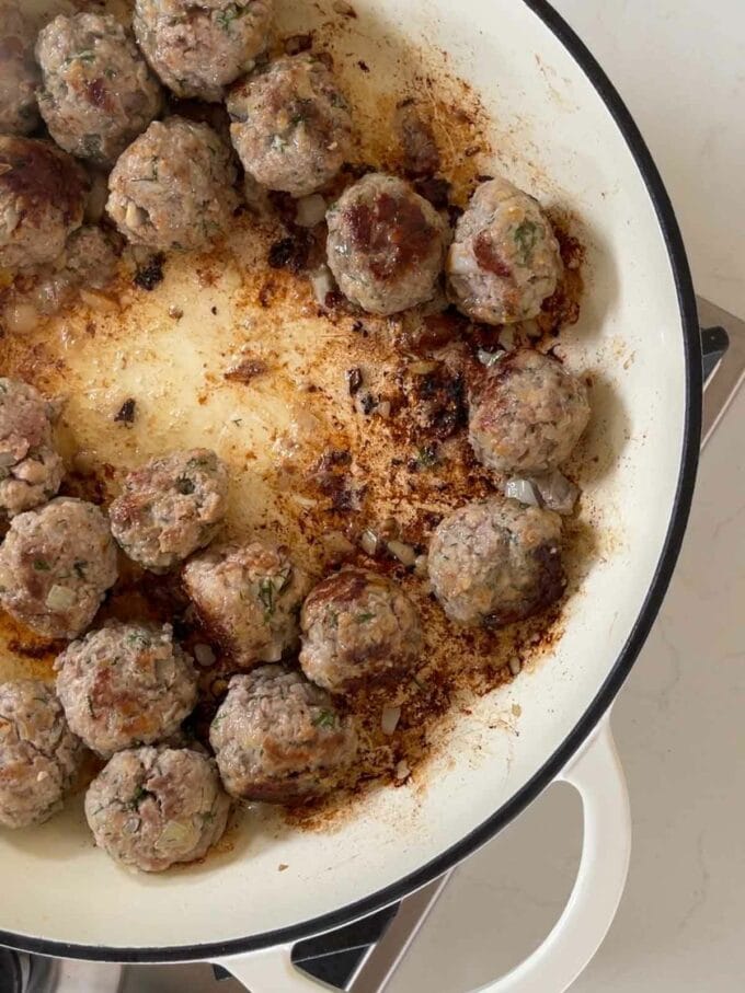 Meatballs frying in the pan.