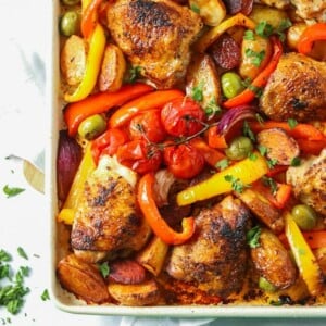 A tray of cooked Chicken and chorizo tray bake with roasted vegetables, ready to eat.