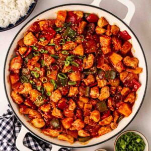 A pan of Sweet and Sour chicken, ready to serve onto plates.