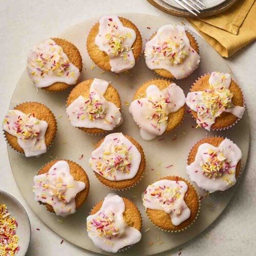 Lots of freshly baked fairy cakes, decorated and ready to eat.