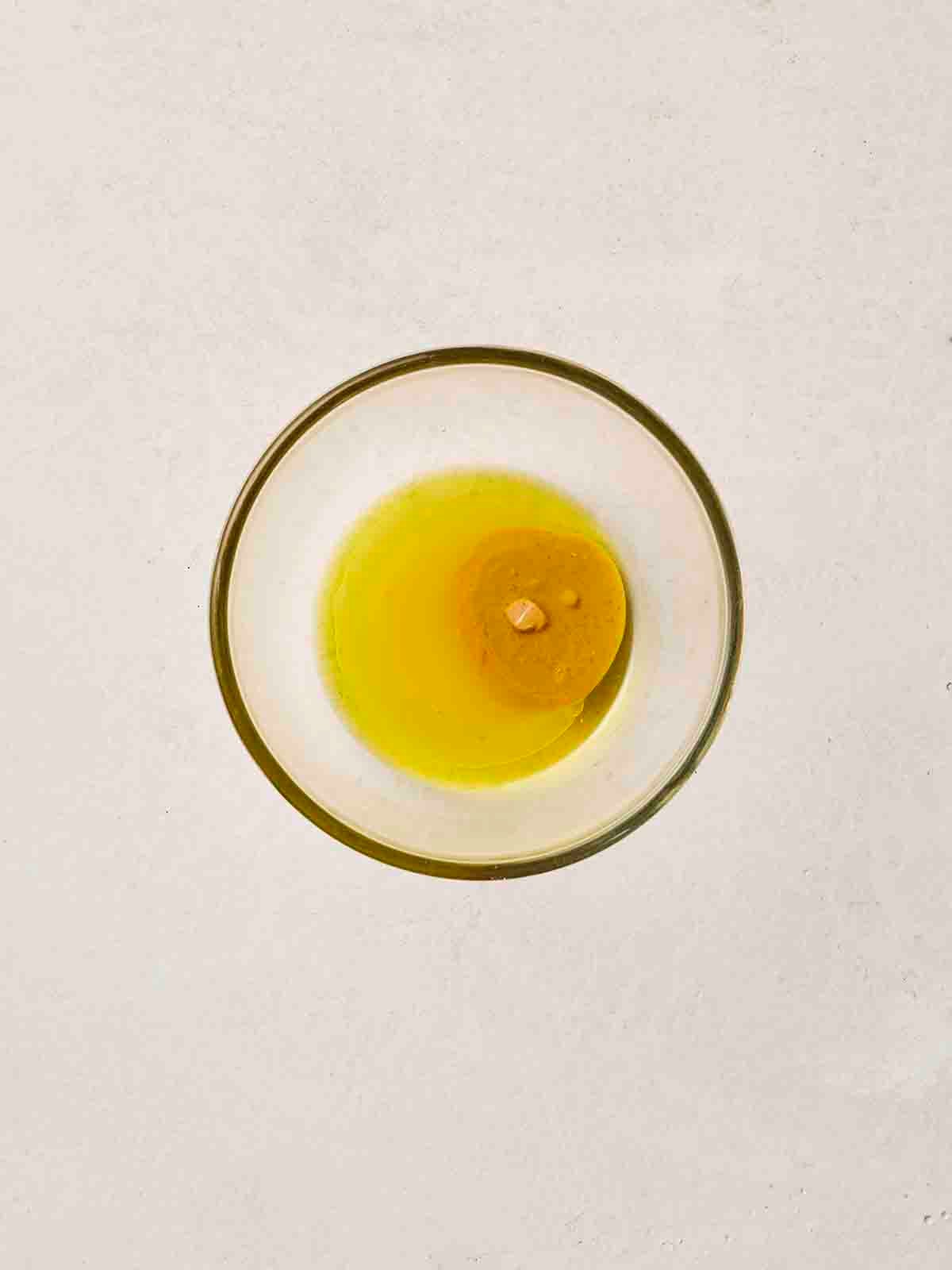 The Rice Salad dressing ingredients in a small glass bowl.