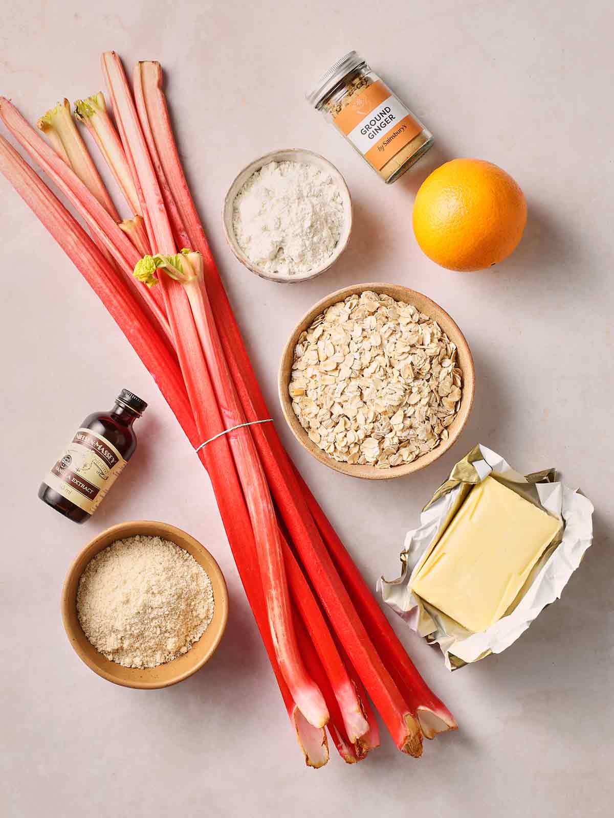 The ingredients for making Rhubarb Crumble laid out on a white counter top.